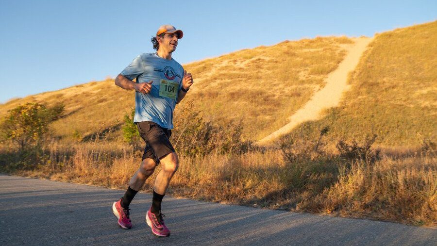 man running past the Sleeping Bear Dunes