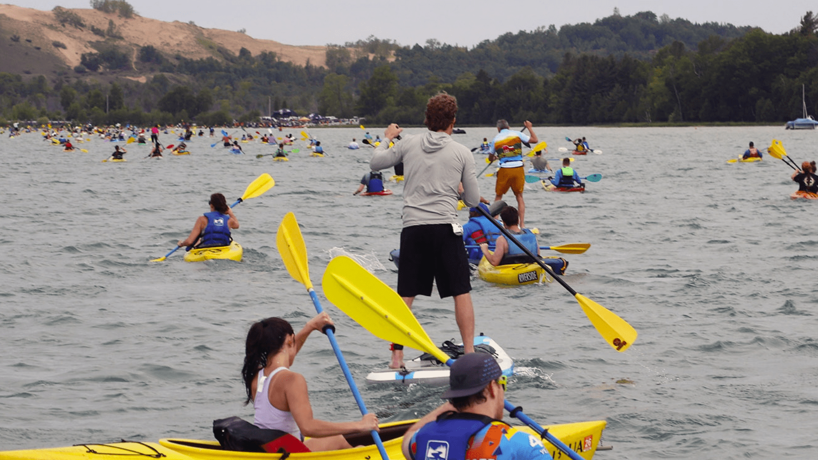 Kayak and SUP paddlers crossing Little Glen Lake during the final leg of the M22 Challenge